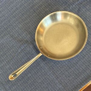 All-Clad 10” Stainless Steel Frying Pan with storage bag.